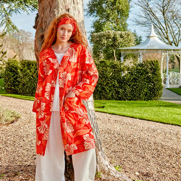 woman in orange kimono near tree